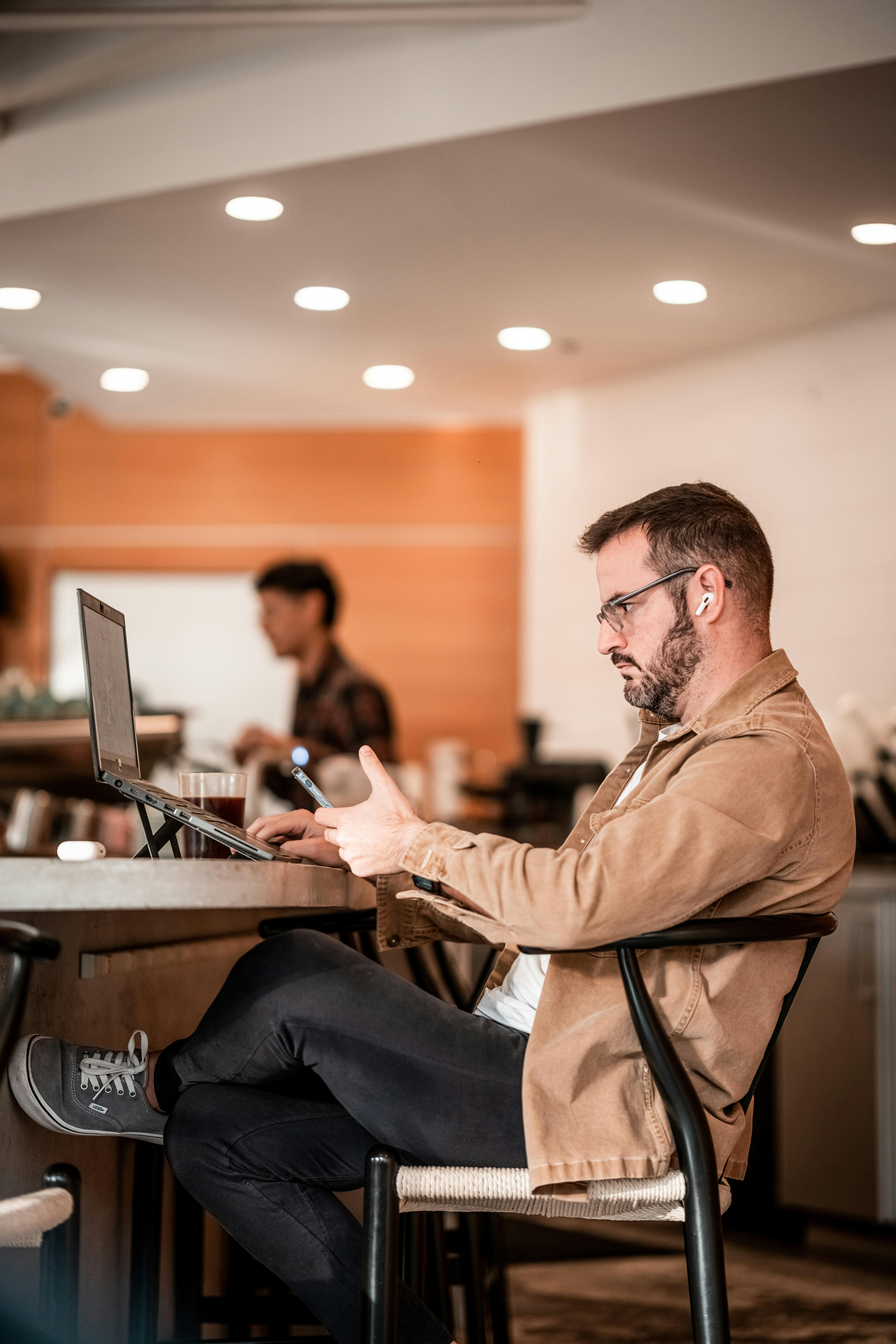 Man working while sitting a coffee shop
