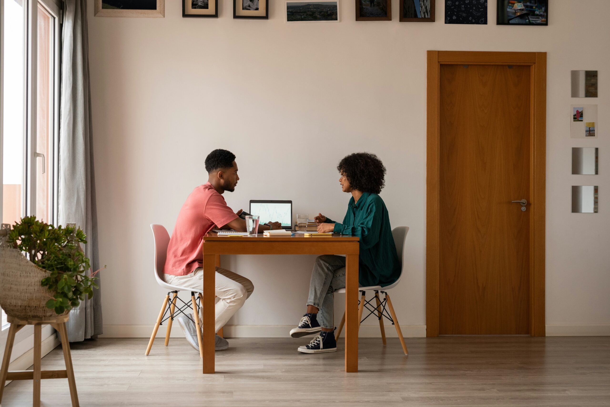 Male and female coworkers gathered at a table tracking prepaid expenses
